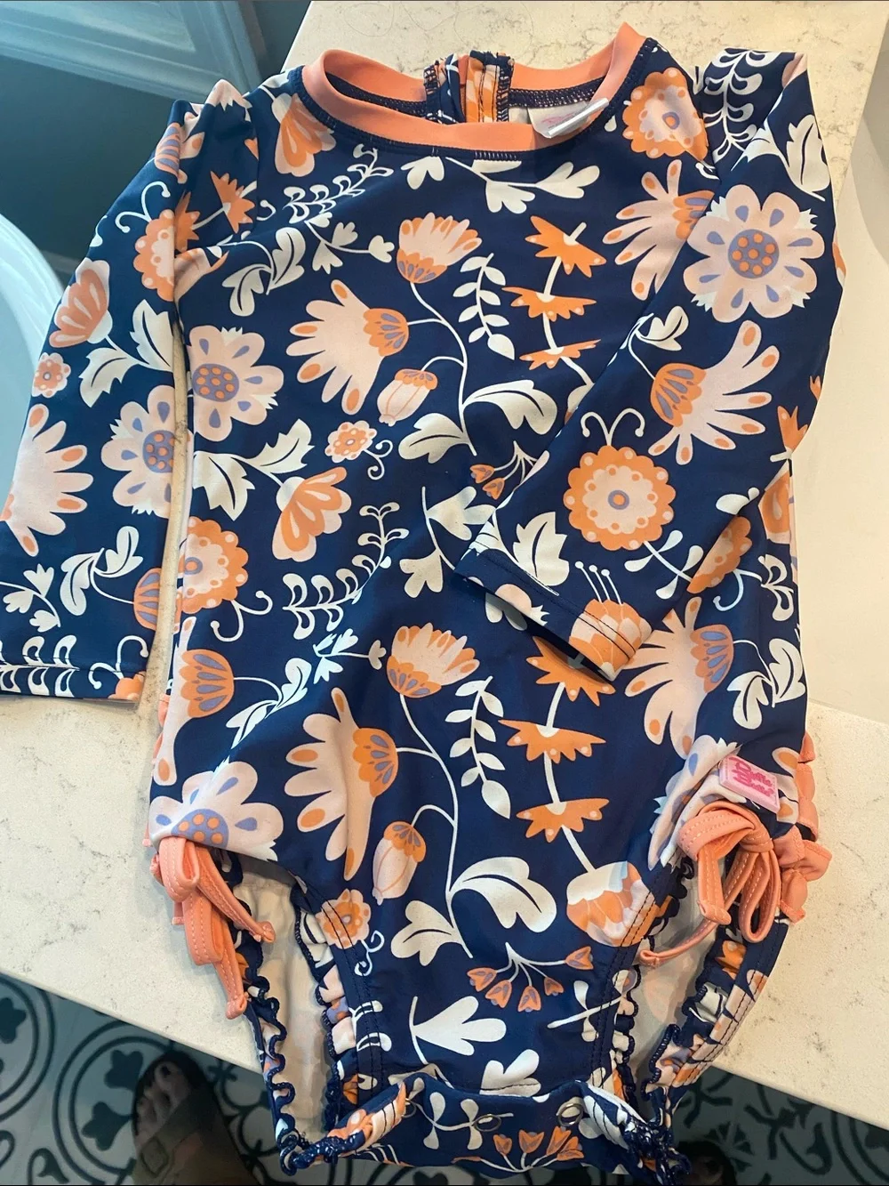 Ruffle Butts Navy Swimsuit with Peach Floral Accents